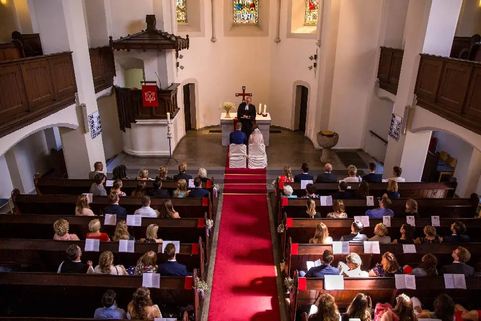 Blick von der Empore über die Gäste auf das Brautpaar am Altar