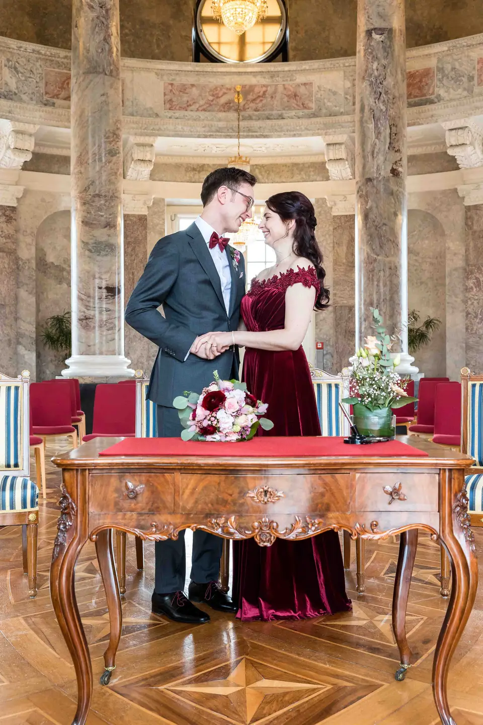 Brautpaar küsst sich am Trautisch in der Rotunde von Schloss Biebrich